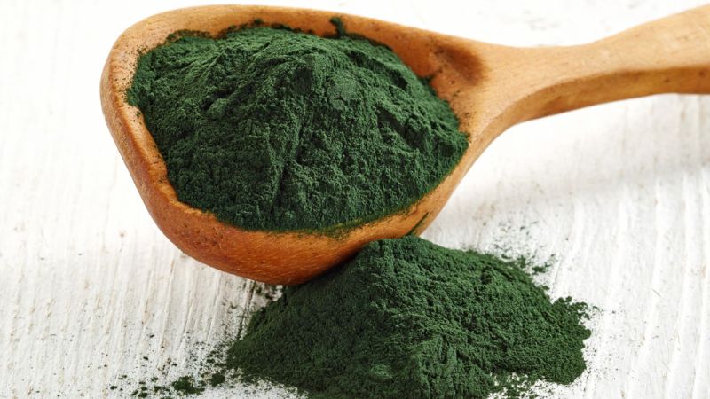 Super greens powder on a spoon